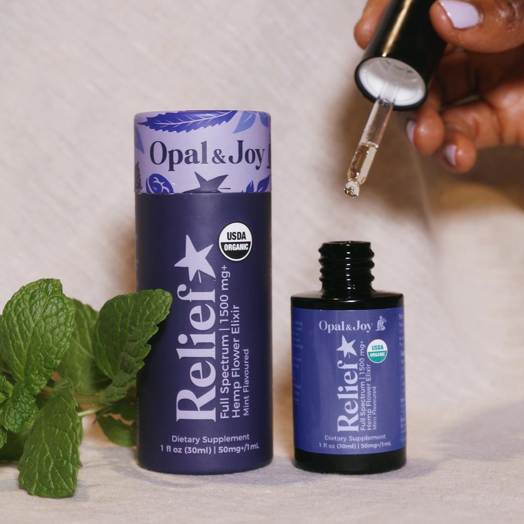 Relief Elixir CBD Oil bottle and tube with natural mint leaves