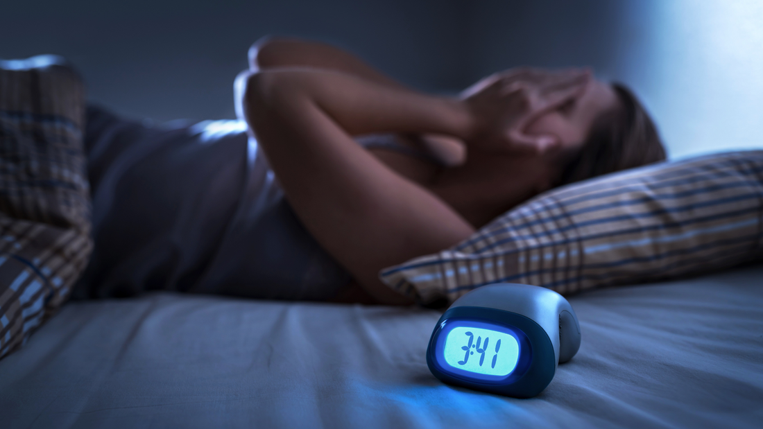 A midlife woman struggles to sleep due to Perimenopause Insomnia
